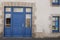 Old shop entrance blue facade store converted into private house in Brittany france