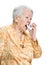 Old sick woman with asthma inhaler