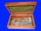 Old silver coins in a box on a blue background