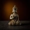 Old silver color statuette Buddha sitting in yoga pose