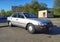 Old silver grey sedan car Toyota Corolla parked