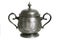 An old silver metal sugar bowl with a lid and ornament. Metal punctles with scratches and patina.