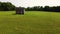 Old small abandoned house in the middle of a field