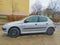 Old small popular compact car white Peugeot 206 parked