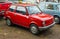 Old small red car Polski Fiat 126p parked front view