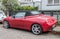 Old small red sport car Alfa Romeo Spider parked left side view