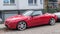 Old small red sport car Alfa Romeo Spider parked left side view