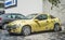Old small sport compact car yellow Opel Tigra parked