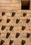 Old small window in a facade of granite blocks and shell moldings on the wall with long shadows from the evening sun in the Casa