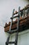 Old, small, wooden ladder leaned against temple wall near the corner