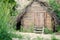 Old solid log cabin shelter hidden in the forest