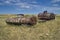 The old Soviet auto and agricultural machinery abandoned in the steppe not far from Sartymbet village, stone mountains