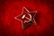 Old Soviet badge with the red star, a sickle and a hammer reminiscent of the cold war era worn by the soldiers of the red army on