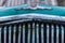 Old Soviet car Volga. Turquoise retro car covered with snow. GAZ-21 on the street