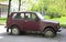 Old Soviet red abandoned rusty short-wheelbase Jeep