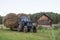 Old soviet tractor with big haystack