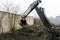 An old Soviet tractor digs and loads waste stone processing