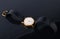 Old soviet wristwatch on black glossy background