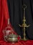 Old Spanish Oil Lamp Glass Demijohn and Silver sugar Bowl Red and Black Background Still Life