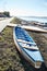 Old or spare sports kayaks on the lake.