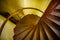 Old spiral metal staircase inside tower, upside view