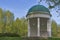 Old spring park with stone gazebo