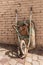 Old Stained Wheelbarrow Leaning on Wall