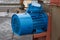 Old stationary engine cleaned and painted blue. engine exhaust system.
