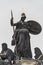 Old statue of a Roman woman with spire and shield at the central historical building Zitronenpresse in downtown of Dresden,