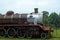 OLD STEAM LOCOMOTIVE AT AN ABANDONED STATION