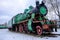 Old steam locomotive wheel and connecting rods. Tie rod or side rod for drive wheels. A retro specimen.