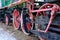 Old steam locomotive wheel and connecting rods. Tie rod or side rod for drive wheels. A retro specimen