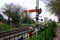 An old steam train line with traditional railway signal next to the railway tracks