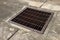 Old steel grate for drainage on concrete floor.