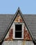 Old steep roof dormer with window.