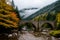 An old stone arch bridge in nature, a river passing beneath it