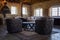 Old stone barn with wooden rafters and round coffee table