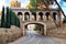 Old stone bridge with arch over the road in ancient medieval castle of Peralada