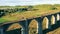 Old stone bridge with a walking woman