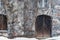 Old stone building detail, door and window, Virginia creeper climbing on weathered rugged wall