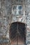 Old stone building detail, door and window, Virginia creeper climbing on weathered rugged wall