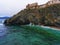 Old stone buildings on the rocks off the coast. The Island Of Elba