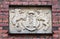 Old stone carved relief with coat of arms of Riga