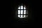 Old stone castle window with iron bars