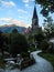 Old Stone Catholic Schlosskirche Castle Church rises over an ornamental Japanese garden with sky background, Interlaken