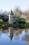 Old stone circular tower in a small rural French Village reflect