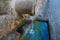 Old stone drinking water fountain in rural Portugal, close up.