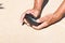 An old stone Hammer an elder man holds in his hands. Archaeology. Study of ancient objects