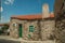 Old stone house with big chimney and wooden door