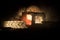 Old stone house burning uncontrollable in the night. A fire in a country house. Creative artwork decoration